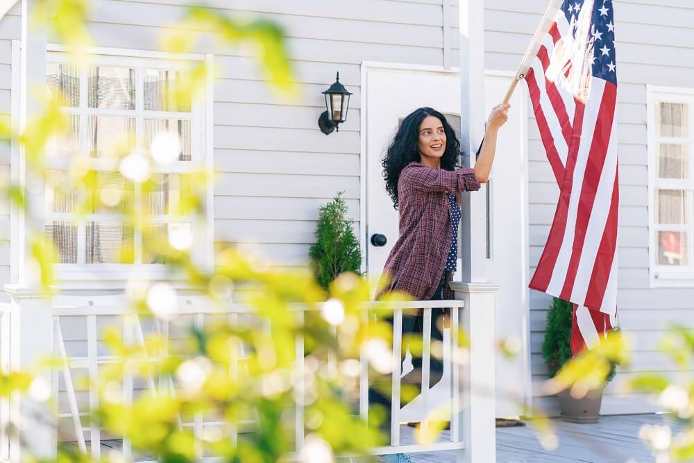 Veteran hanging American Flag on her front porch.