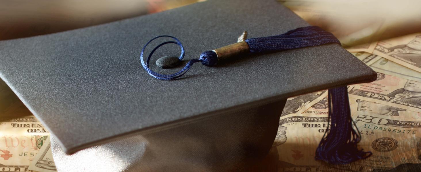 student graduation hat on loan money