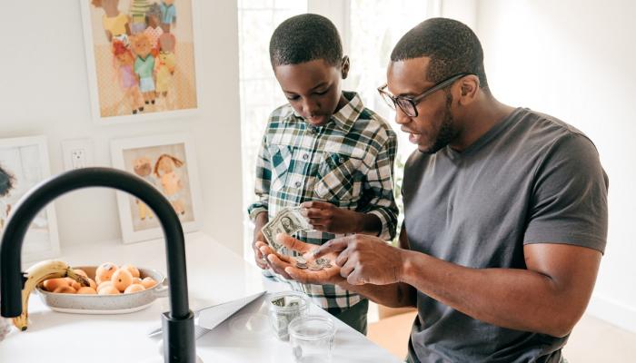Father and son discuss saving money.
