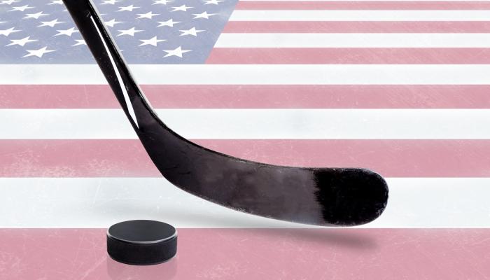 Hockey stick and puck with American flag background.