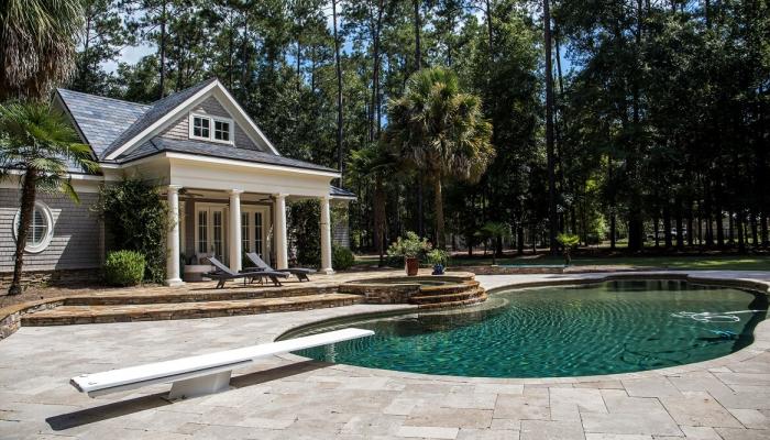 Large home with grotto style pool in backyard.