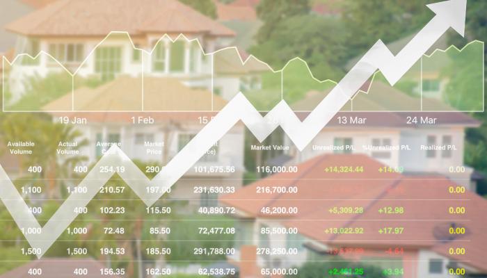 Rising housing market statistics overlayed onto aerial shot of homes. 