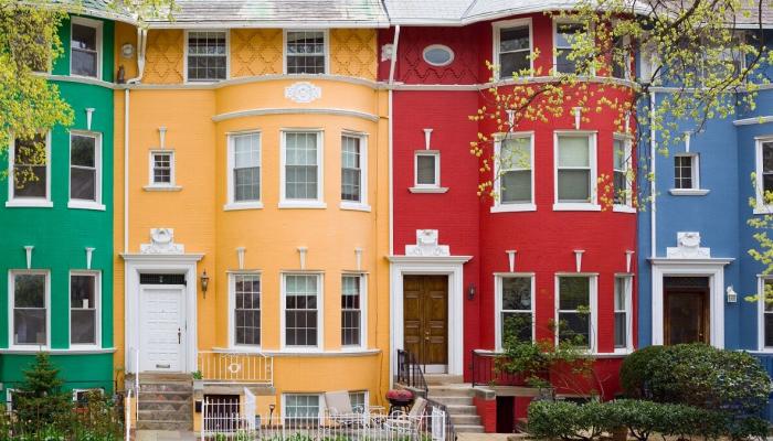 Four colorful townhouses build side by side.