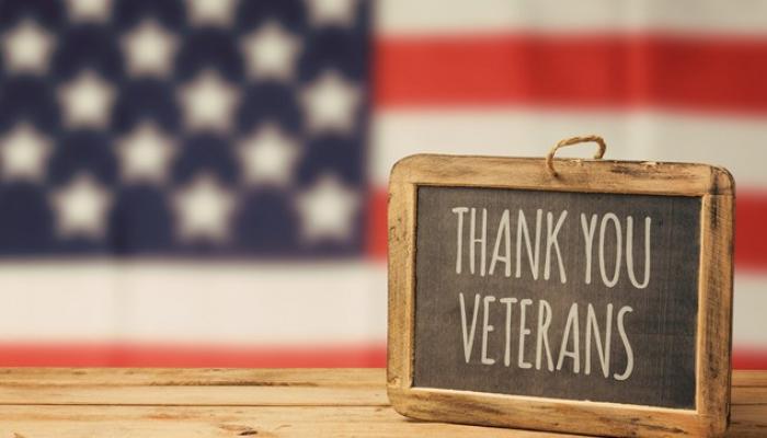 Thank you Veterans sign sitting on wooden table.