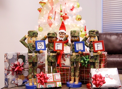 Army themed Nutcrackers pose with Elf on the Shelf.