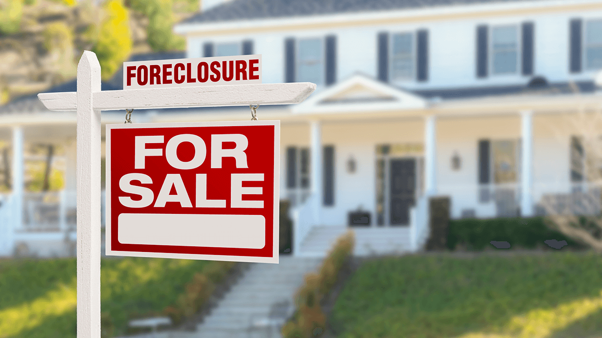 Red foreclosure sign in front of a home.