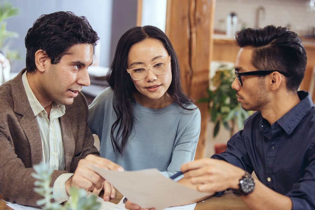 Couple reviews a mortgage offer with their lender.