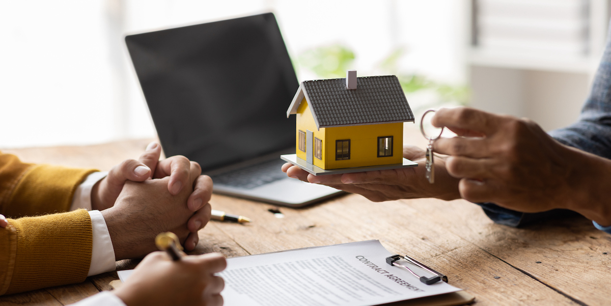 Couple at their closing day meeting to buy their second home.