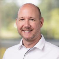 headshot image of Corey Schmidt