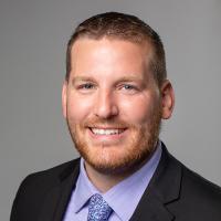 headshot image of DJ Monaghan