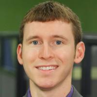 headshot image of Tom Champion