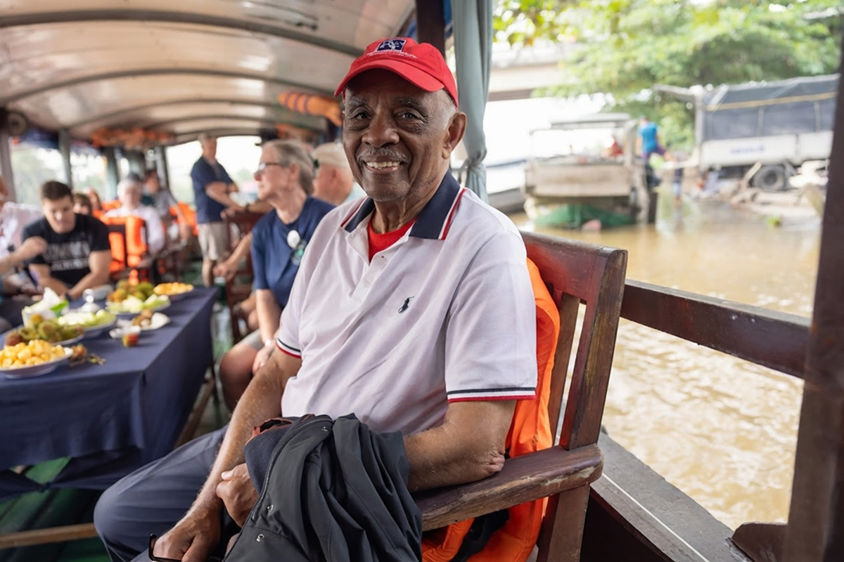 Buddie Joe "BJ" Penn smiling aboard a boat on a river in Vietnam.