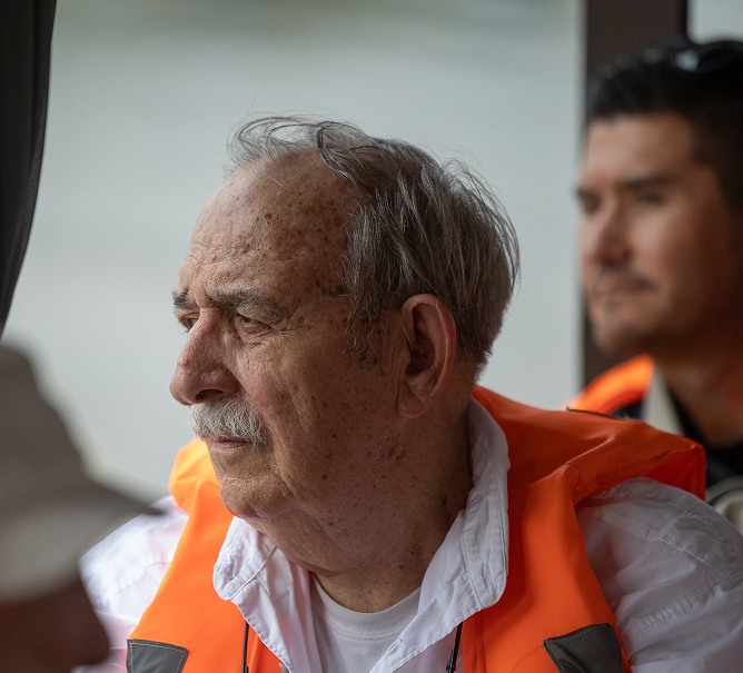 Michael &quote;Mike&quote; Mike D. Gilpin wearing a life vest, gazing out from a boat on a river in Vietnam.