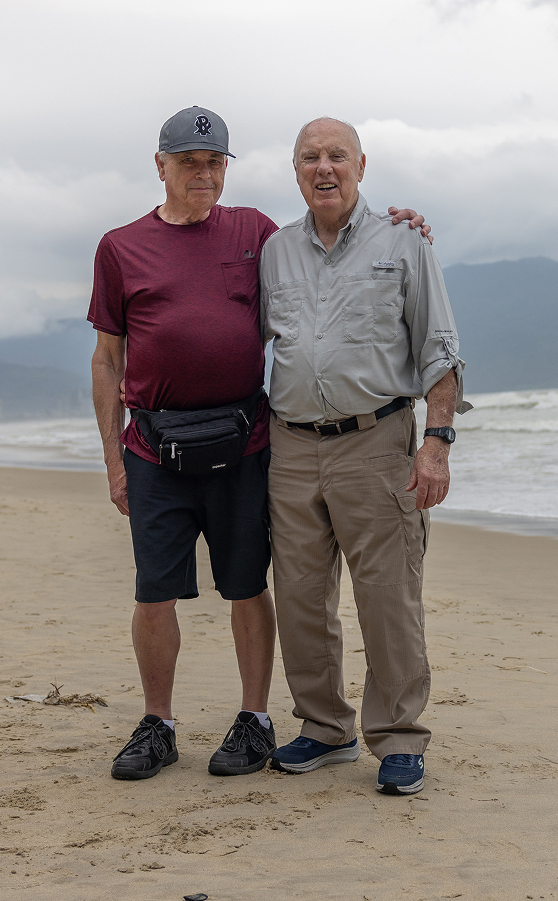 James Taylor posing with a friend on a beach in Vietnam.