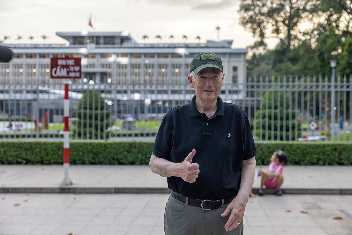 Richard "Rich" Coachys giving a thumbs up outside the Reunification Palace in Ho Chi Minh City, Vietnam.