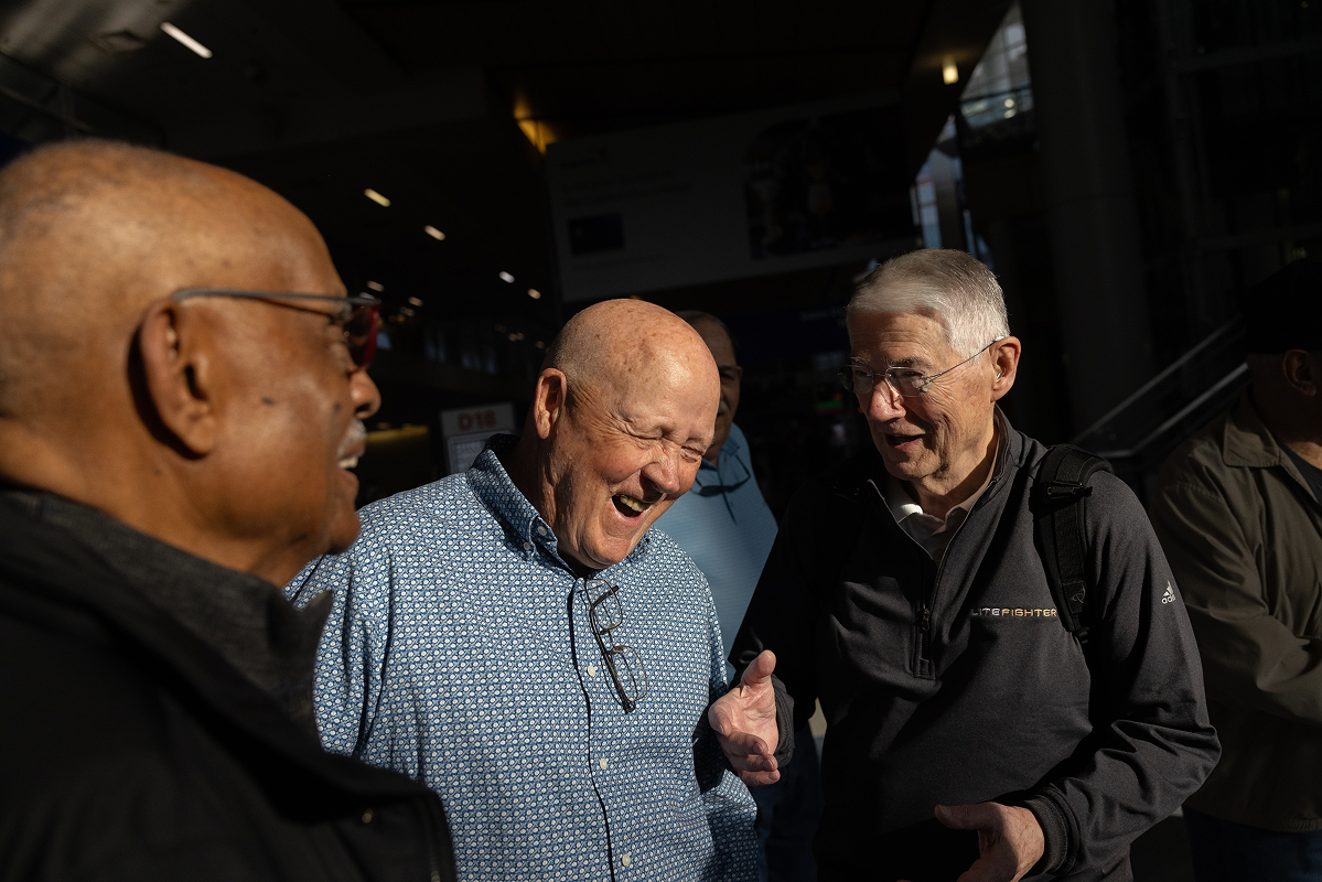 Everett "Vern" Kincheloe laughing with fellow veterans in a group gathering.
